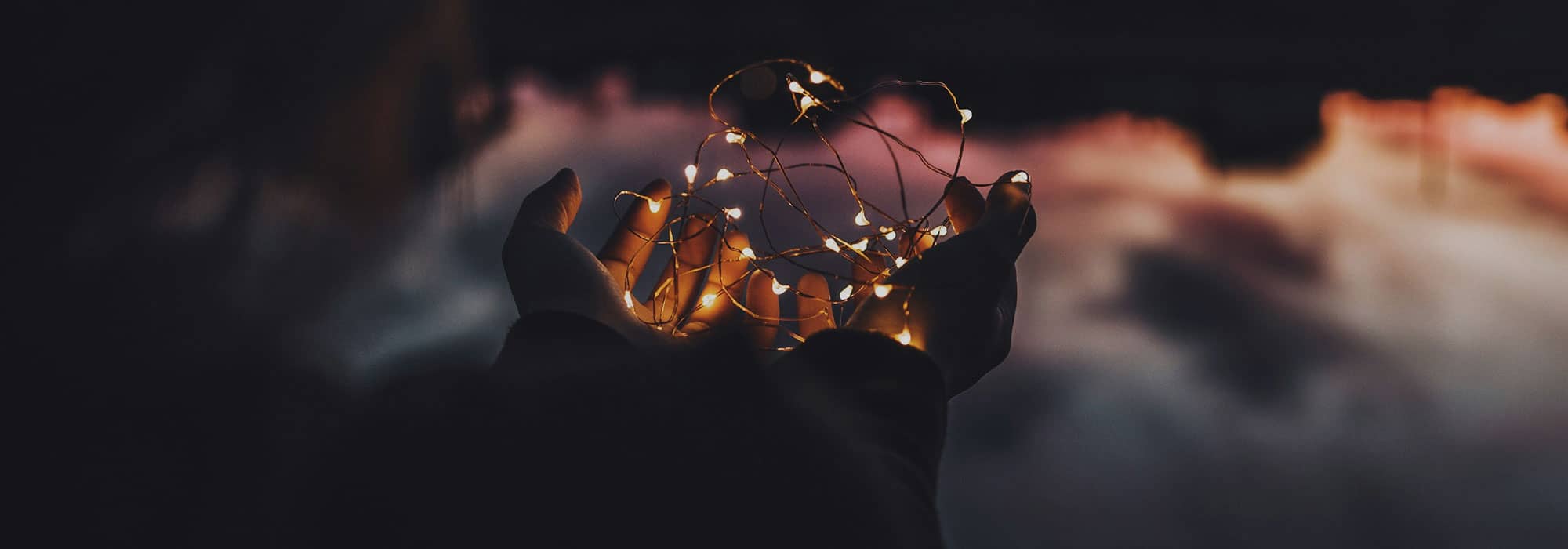 Hands holding small lights